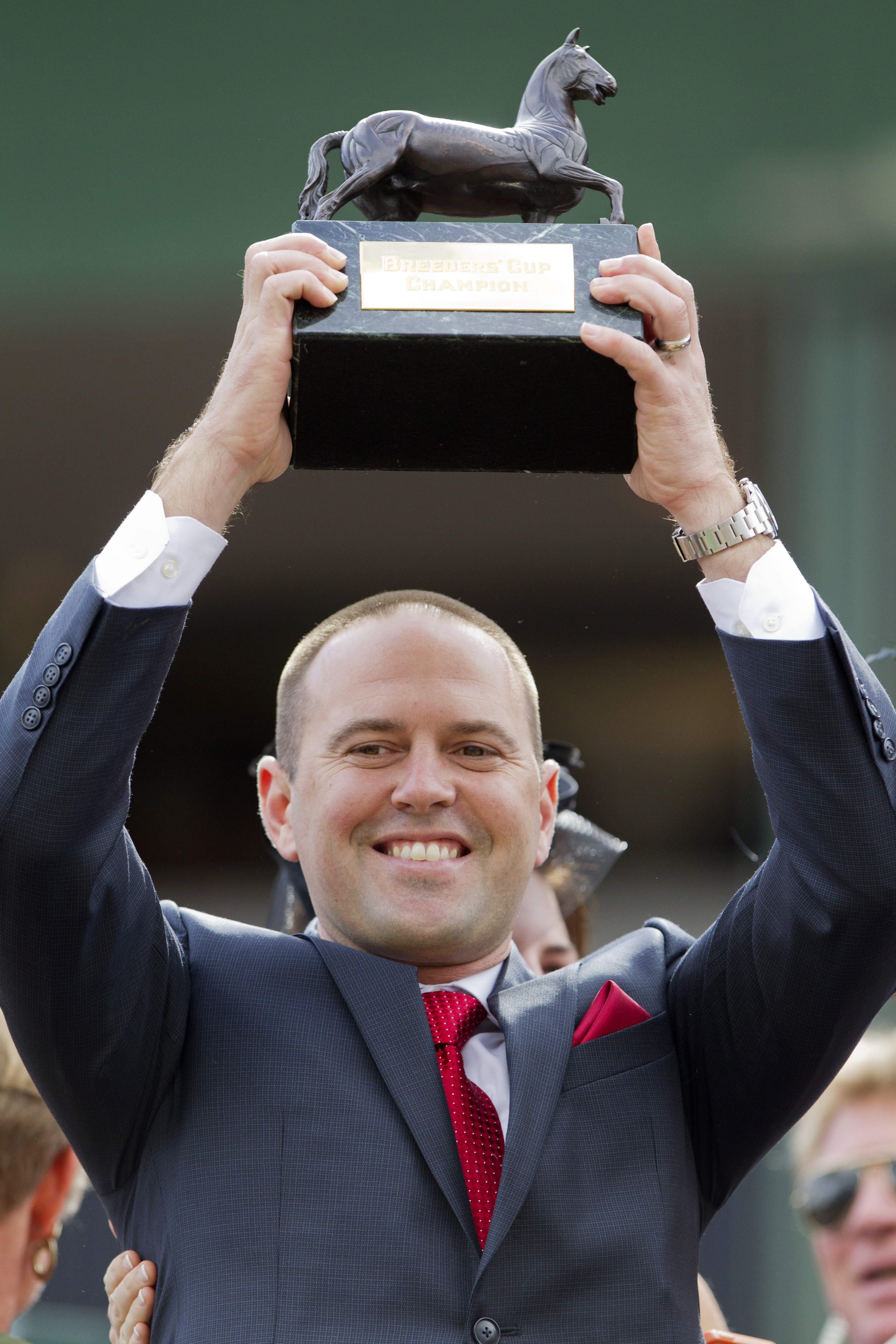 Chad Brown hoists a Breeders' Cup trophy
