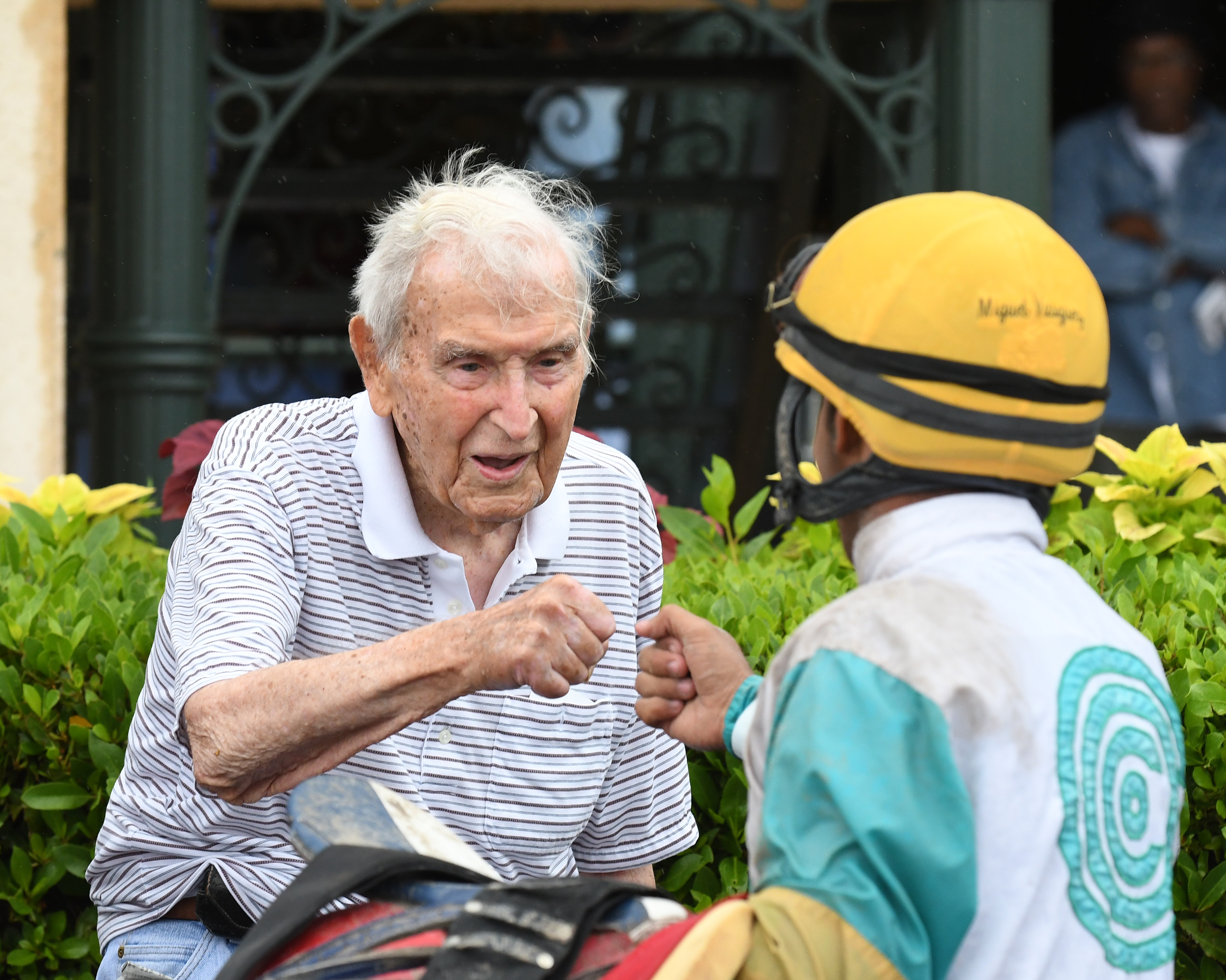 Jerry Bozzo fist bumps jockey Miguel Vasquez after winning a Gulfstream race