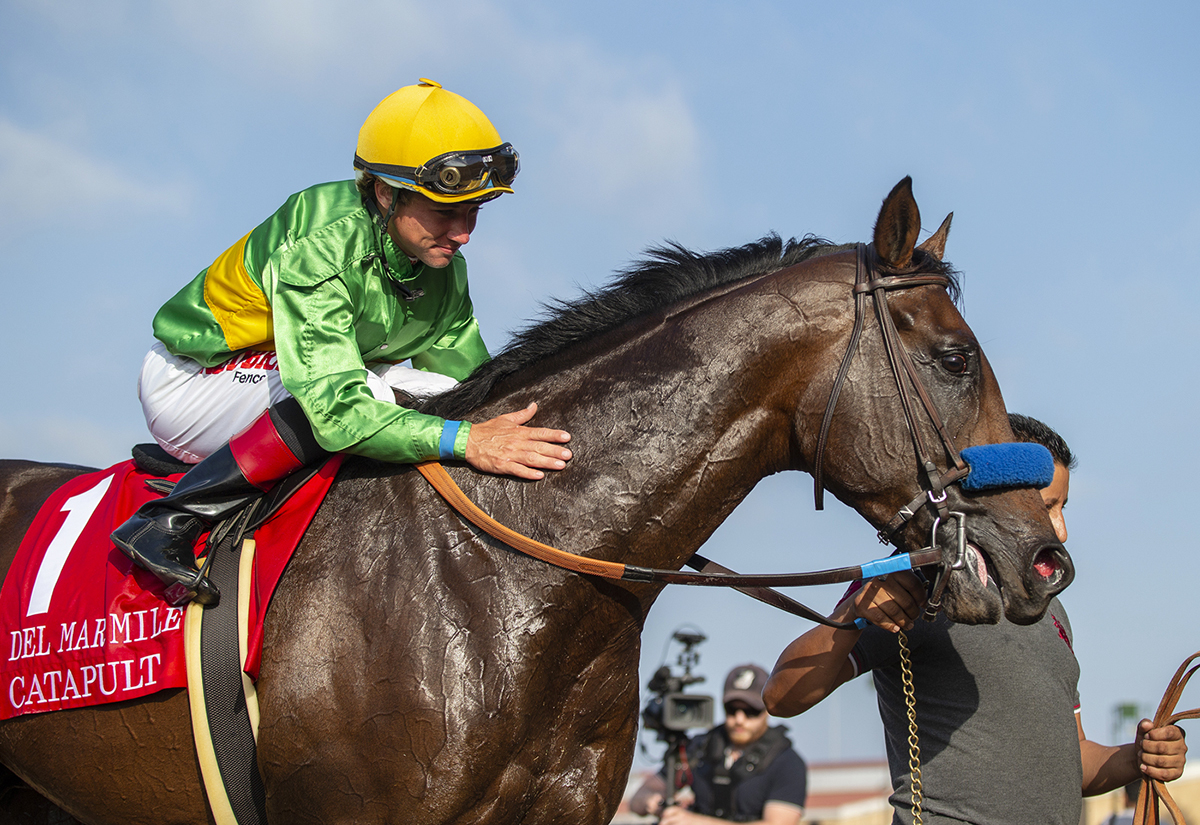 Drayden Van Dyke pats Catapult after winning the Del Mar Mile