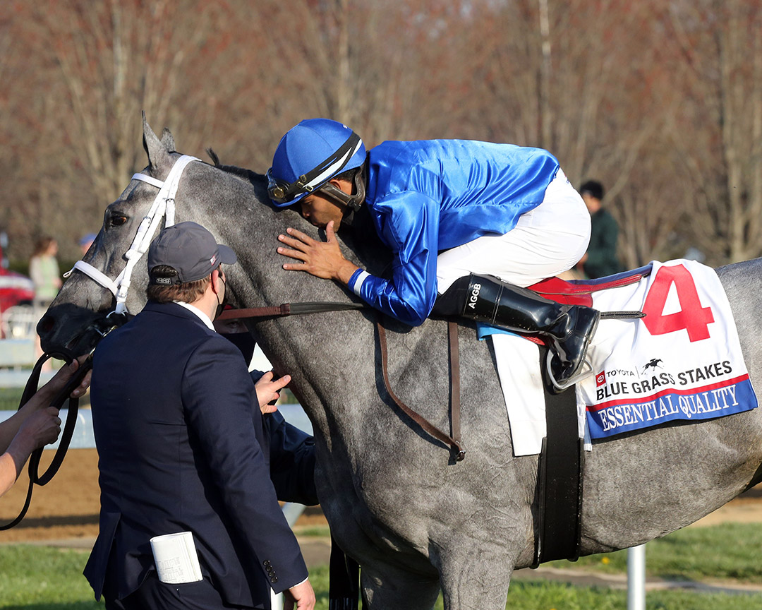 Luis Saez kisses Essential Quality after winning the Blue Grass Stakes at Keeneland