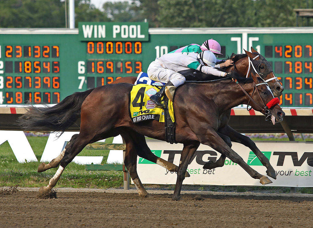 Hot Rod Charlie (outside) crosses the finish line first in the 2021 Haskell Stakes