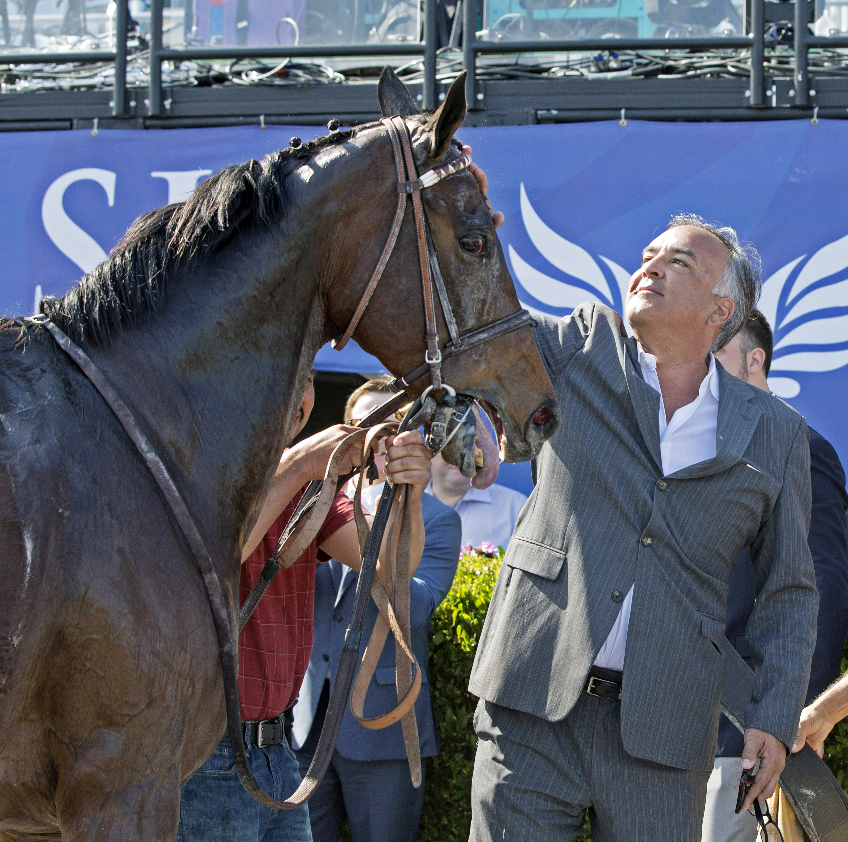 Imperative and trainer Bob Hess after the Poseidon Handicap