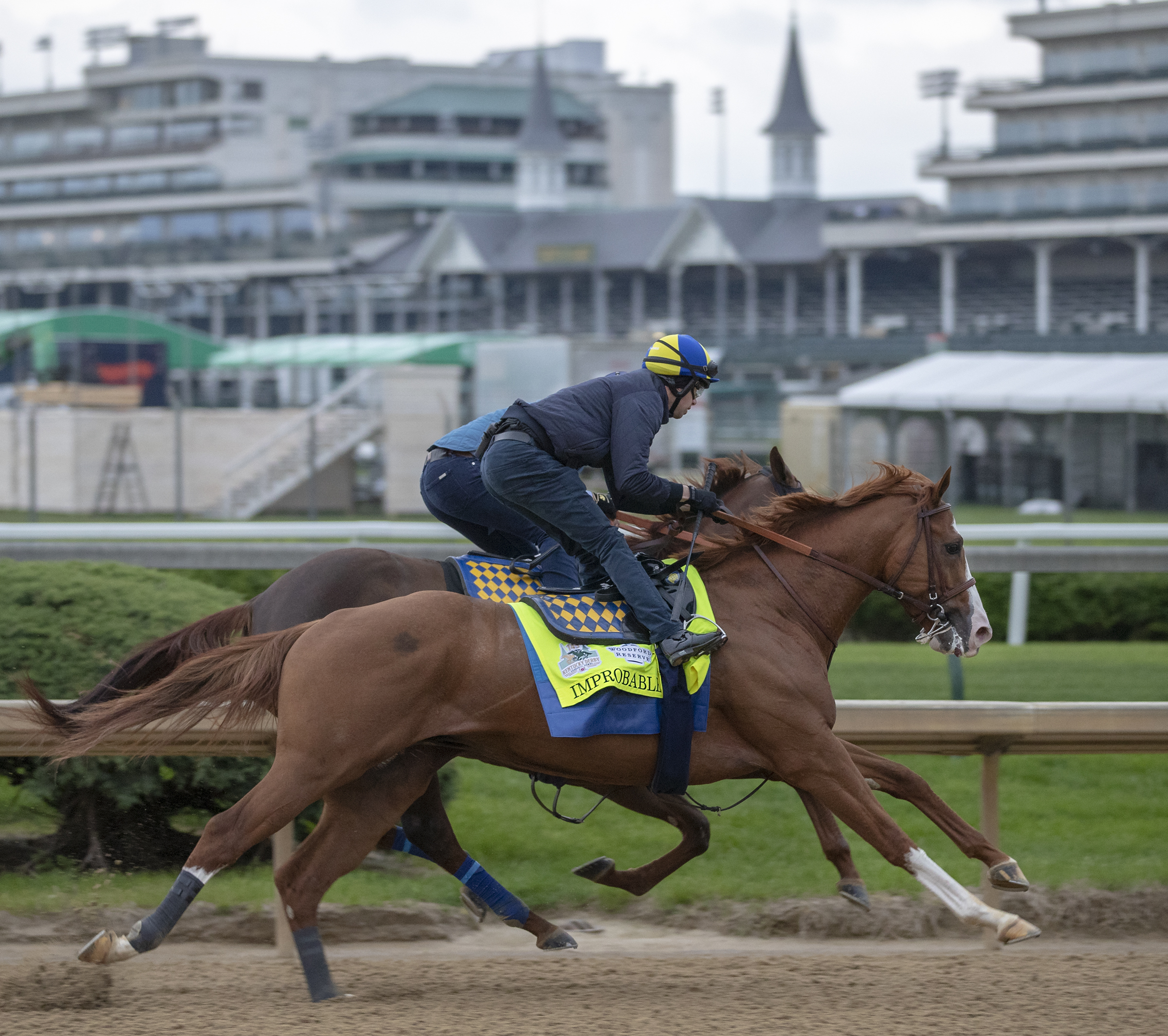 Improbable (outside) works on 4.28.19 at Churchill Downs