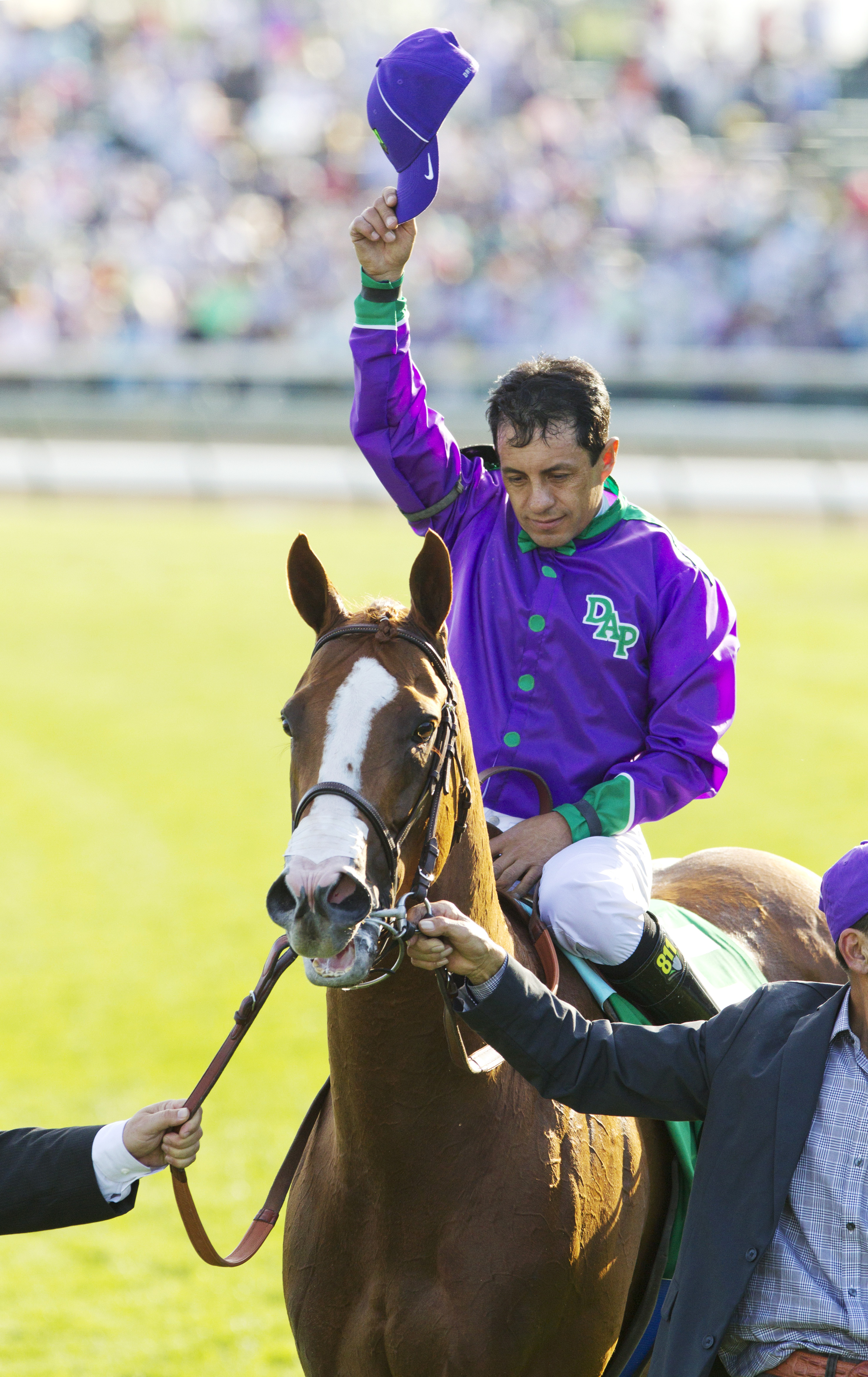 Victor Espinoza raises his hat after the Kentucky Derby