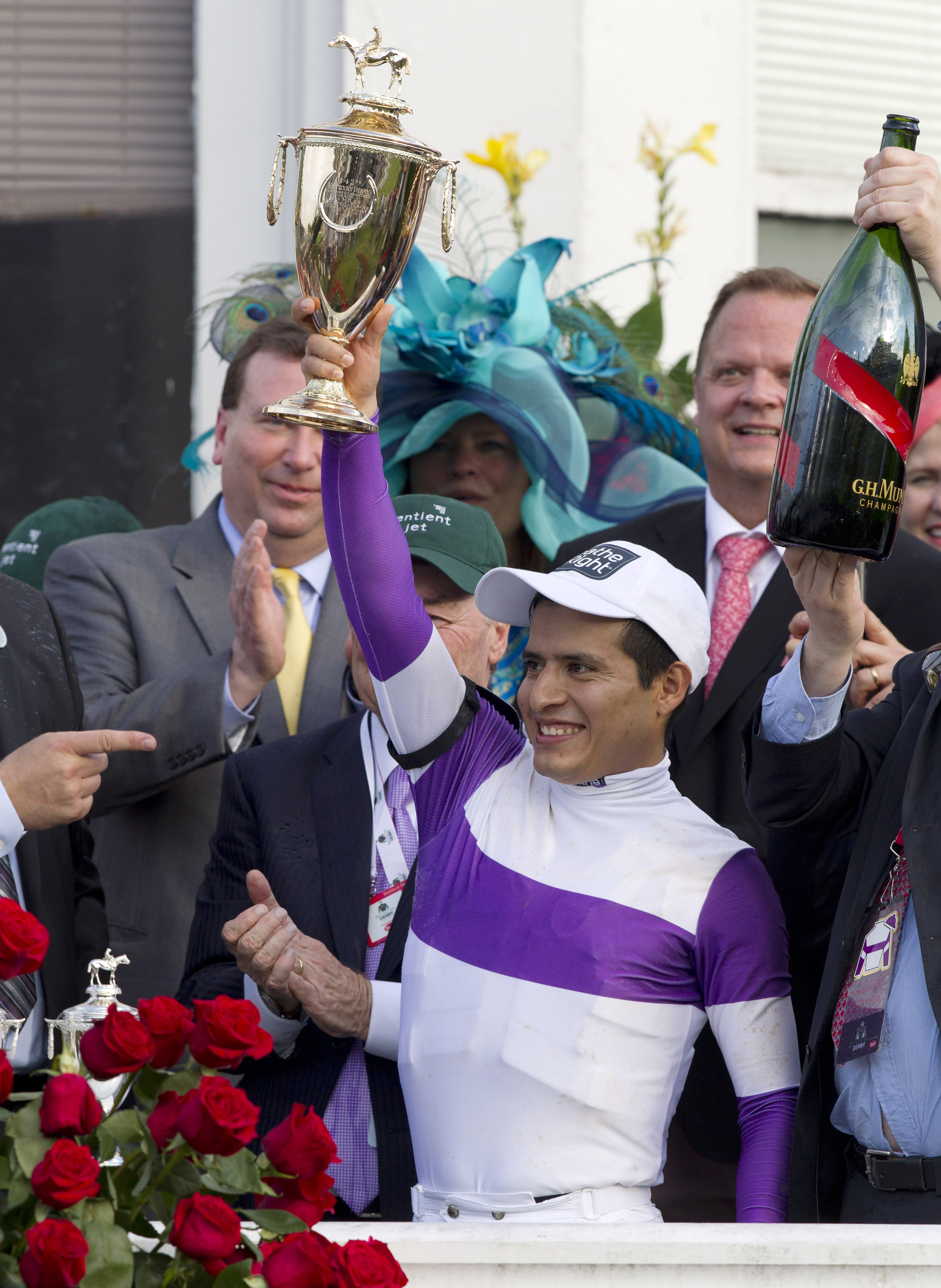 Mario Gutierrez raises the Kentucky Derby trophy