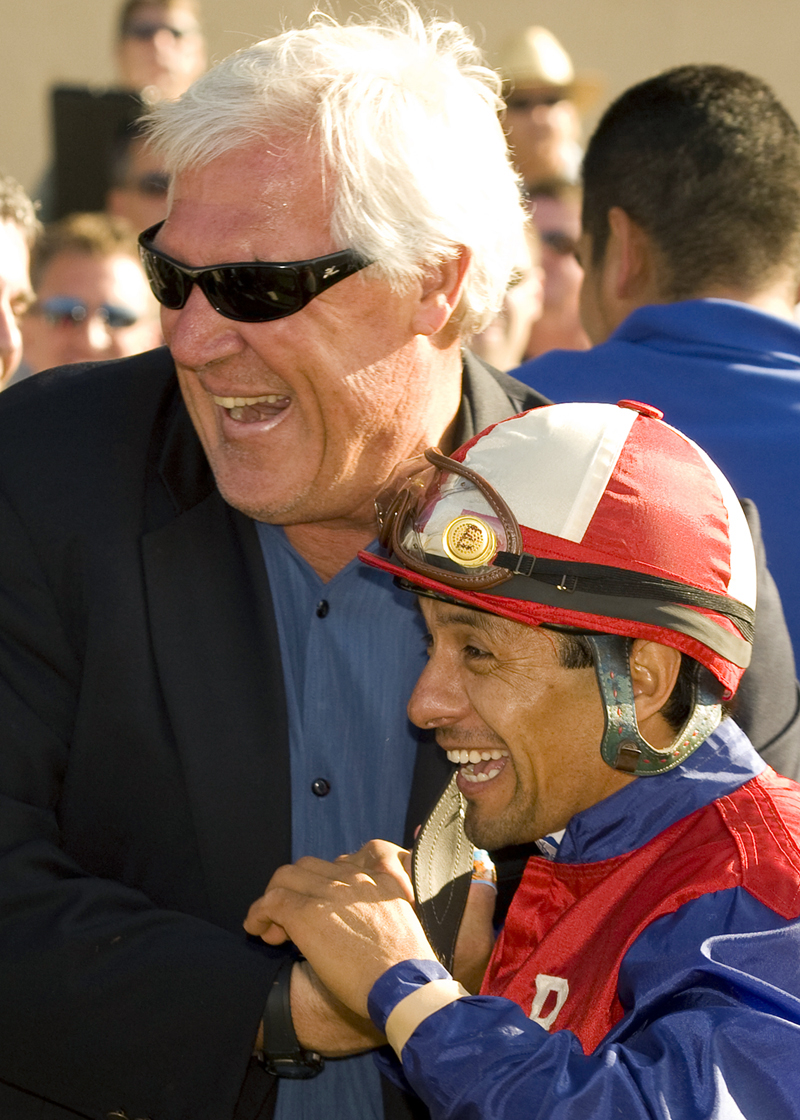 Phil Lebherz celebrates with Victor Espinoza after winning the 2010 Bing Crosby Stakes