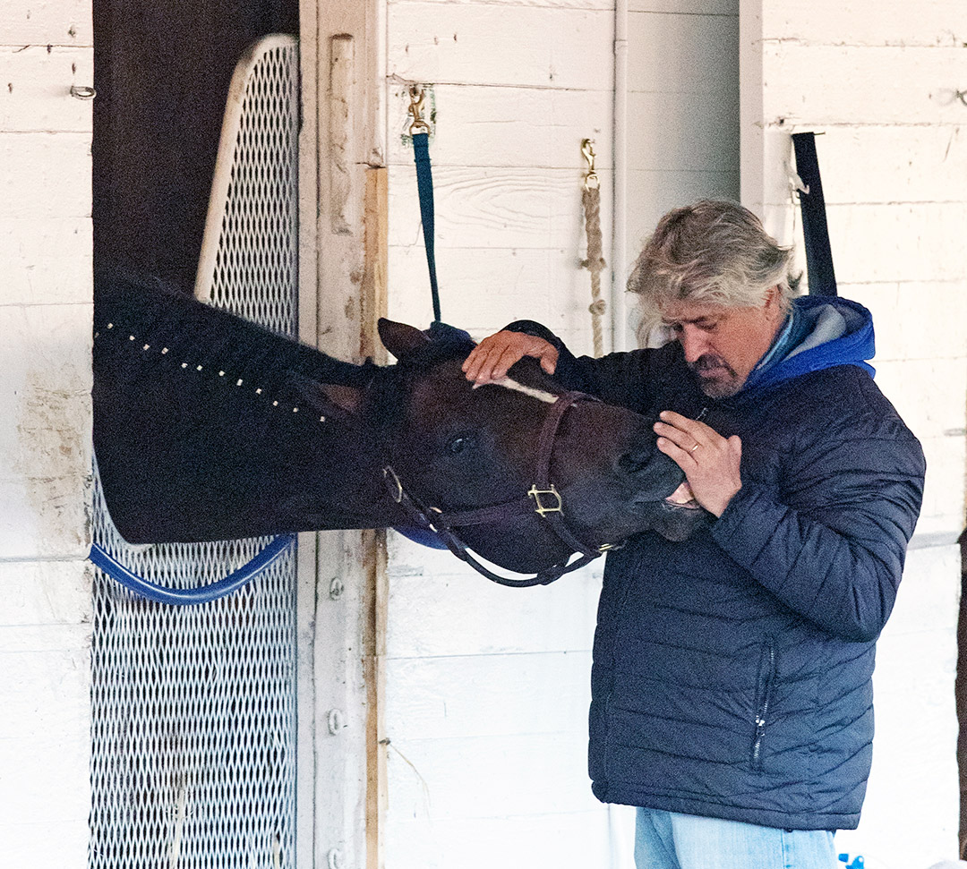Trainer Steve Asmussen with Midnight Bourbon in his stall at Churchill Downs on April 13