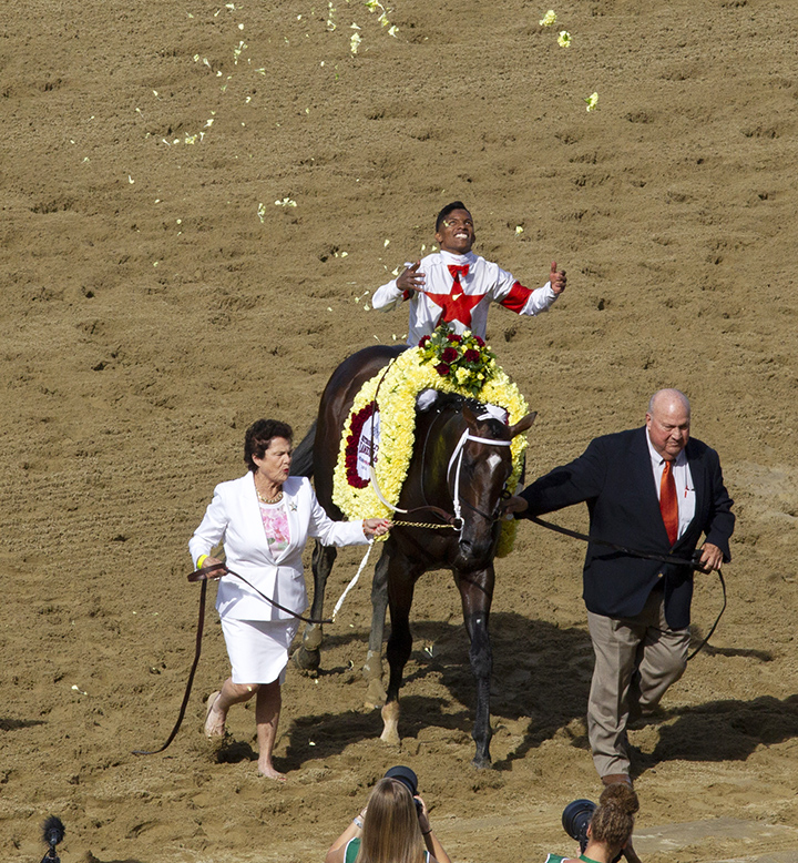Bill and Corinne Heiligbrodt lead Mitole after the Met Mile at Belmont Park