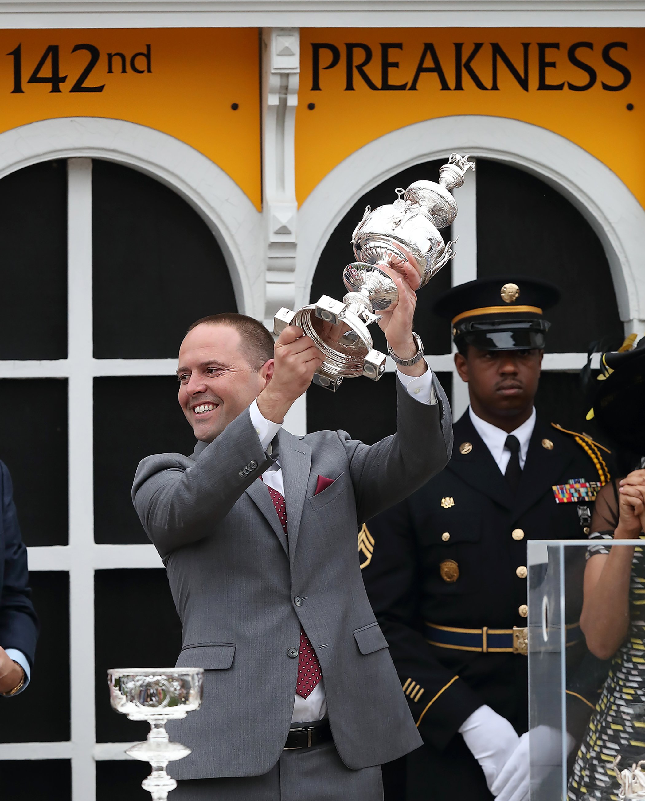 Chad Brown hoists the Preakness trophy