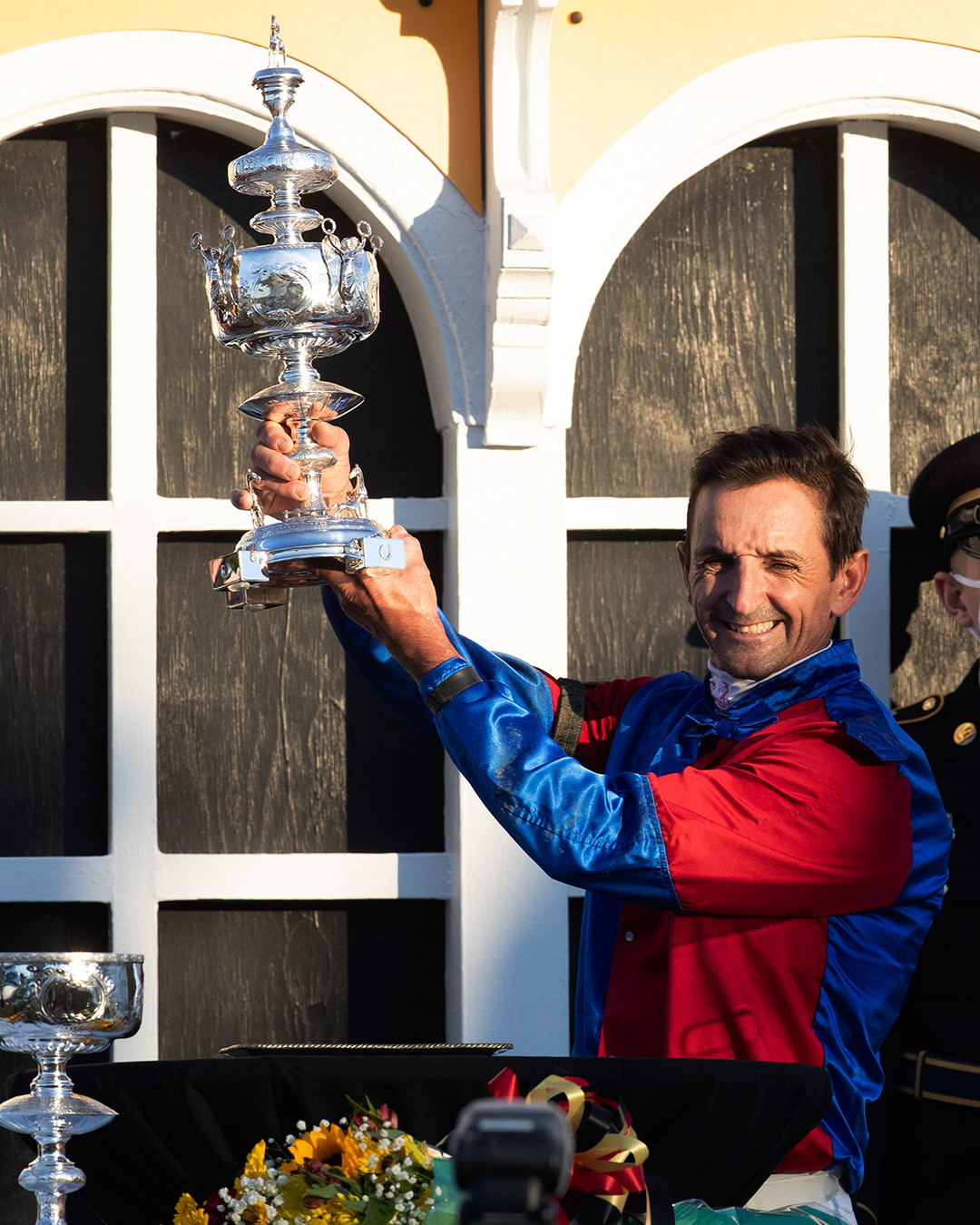 Robby Albarado holds the Preakness trophy after winning with Swiss Skydiver