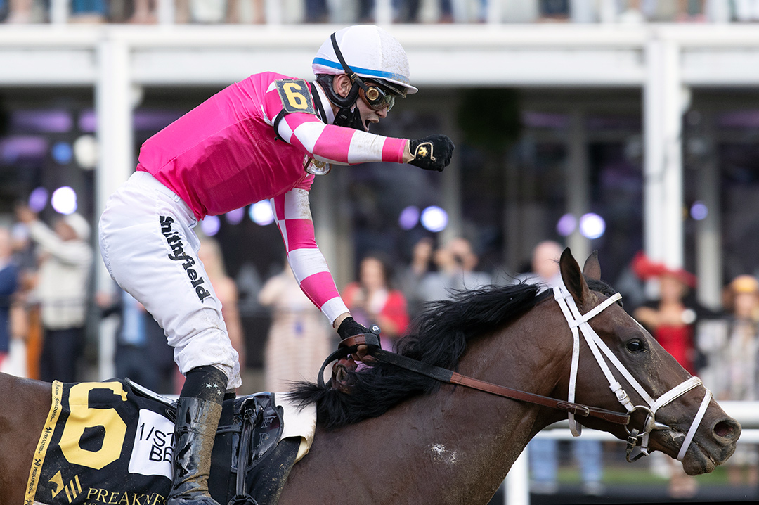 Flavien Prat celebrates after winning the Preakness Stakes aboard Rombauer