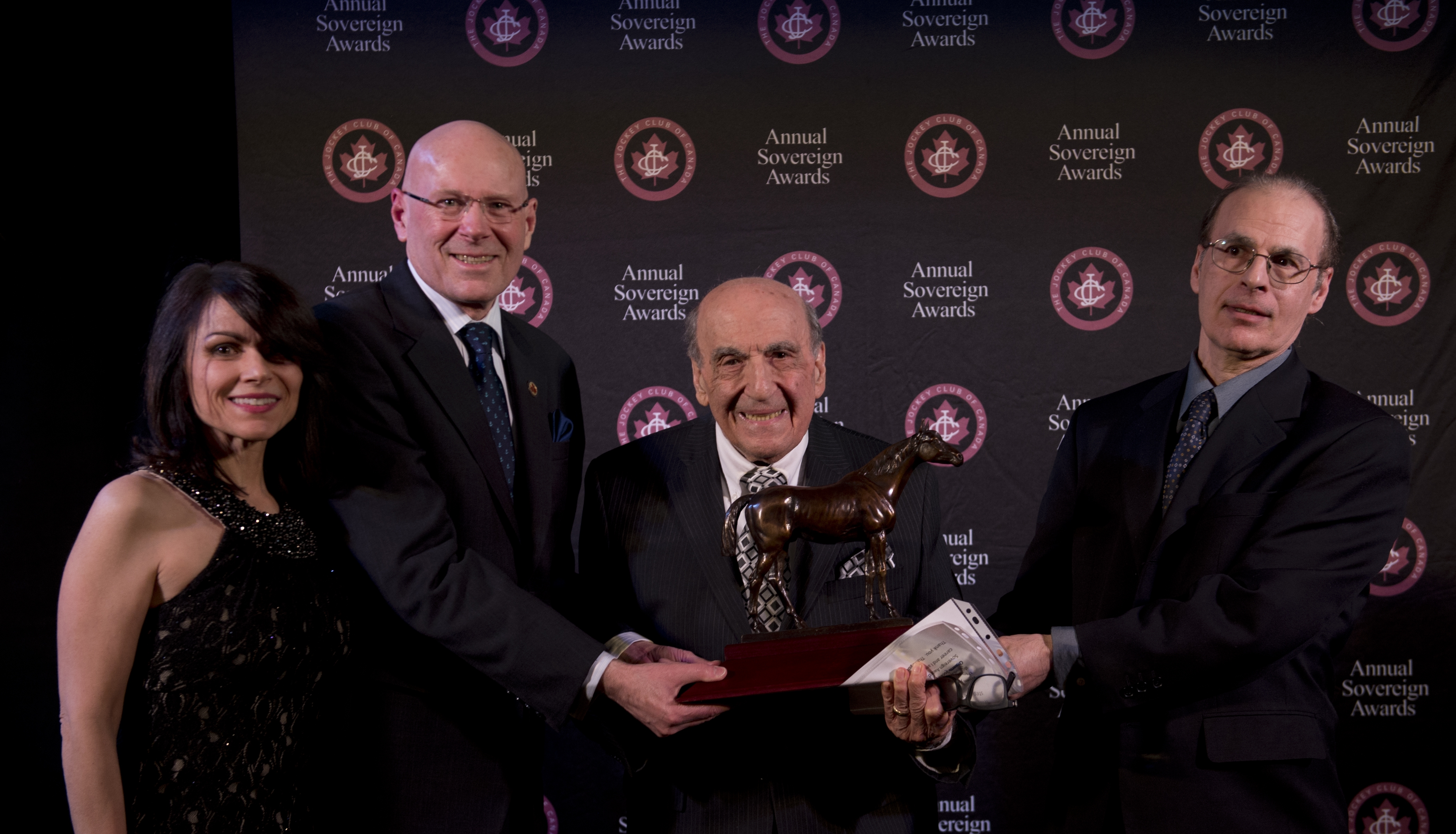 Sam Lima (center) receives a special Sovereign Award in 2018