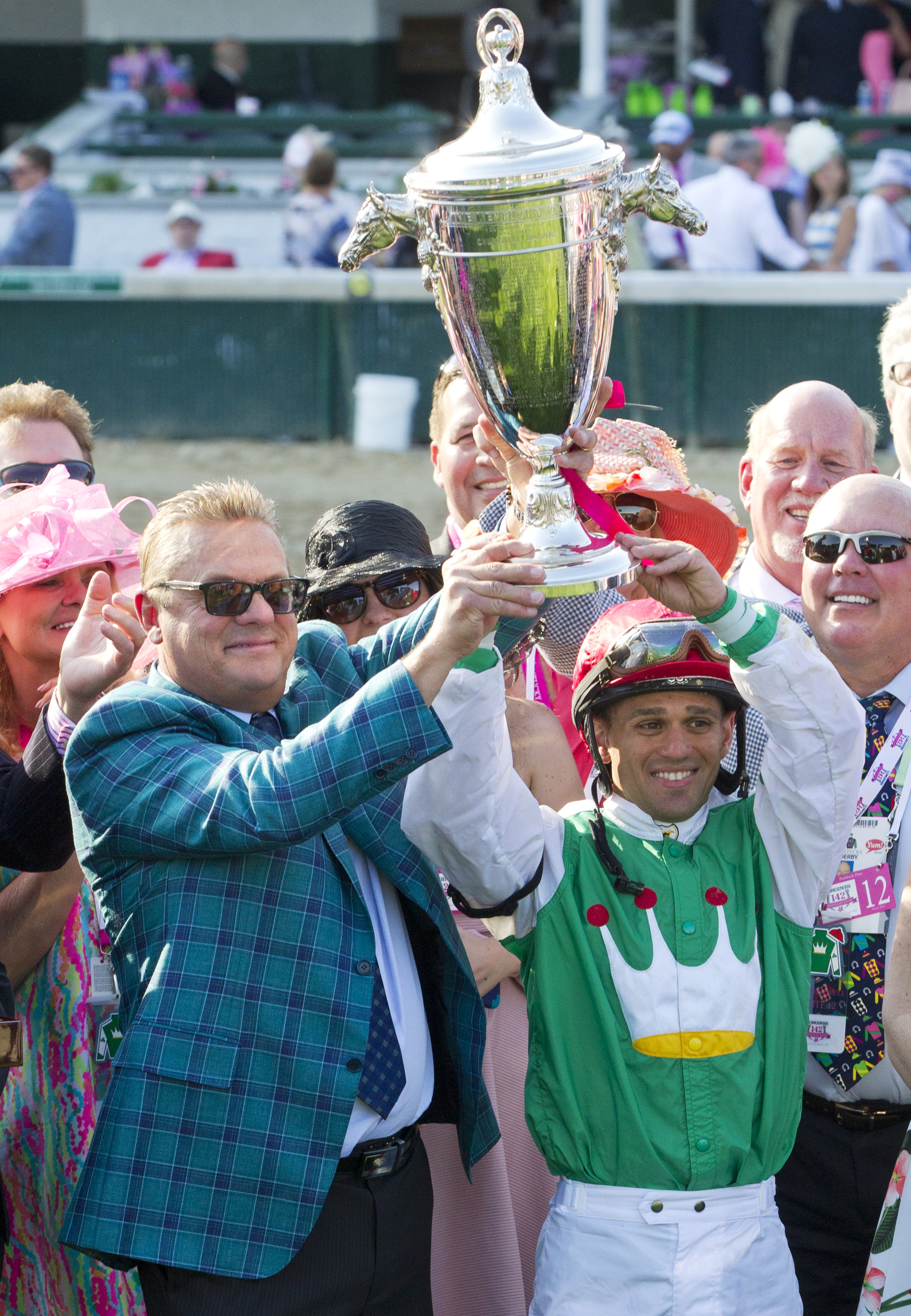 John Servis and Javier Castellano raise the trophy after winning the Kentucky Oaks