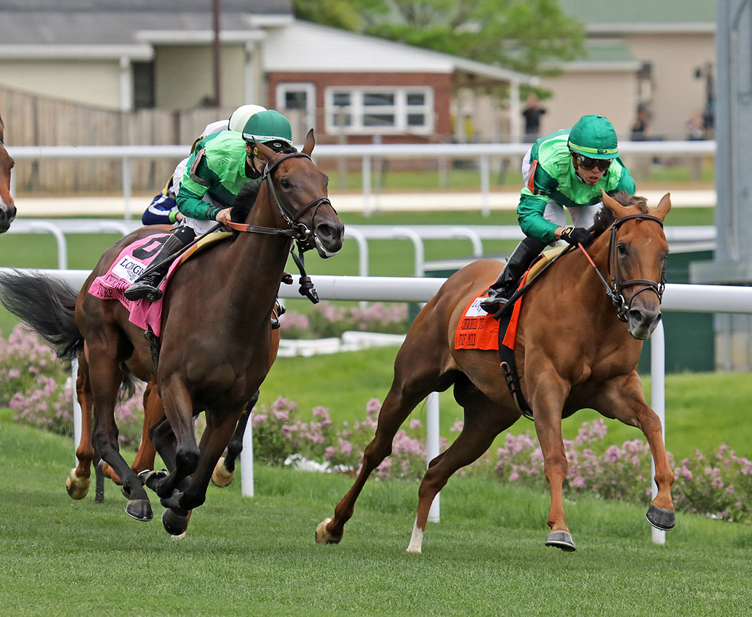 Speak of the Devil (left) and In Italian come out of the final turn of the Churchill Distaff Turf Mile at Churchill Downs