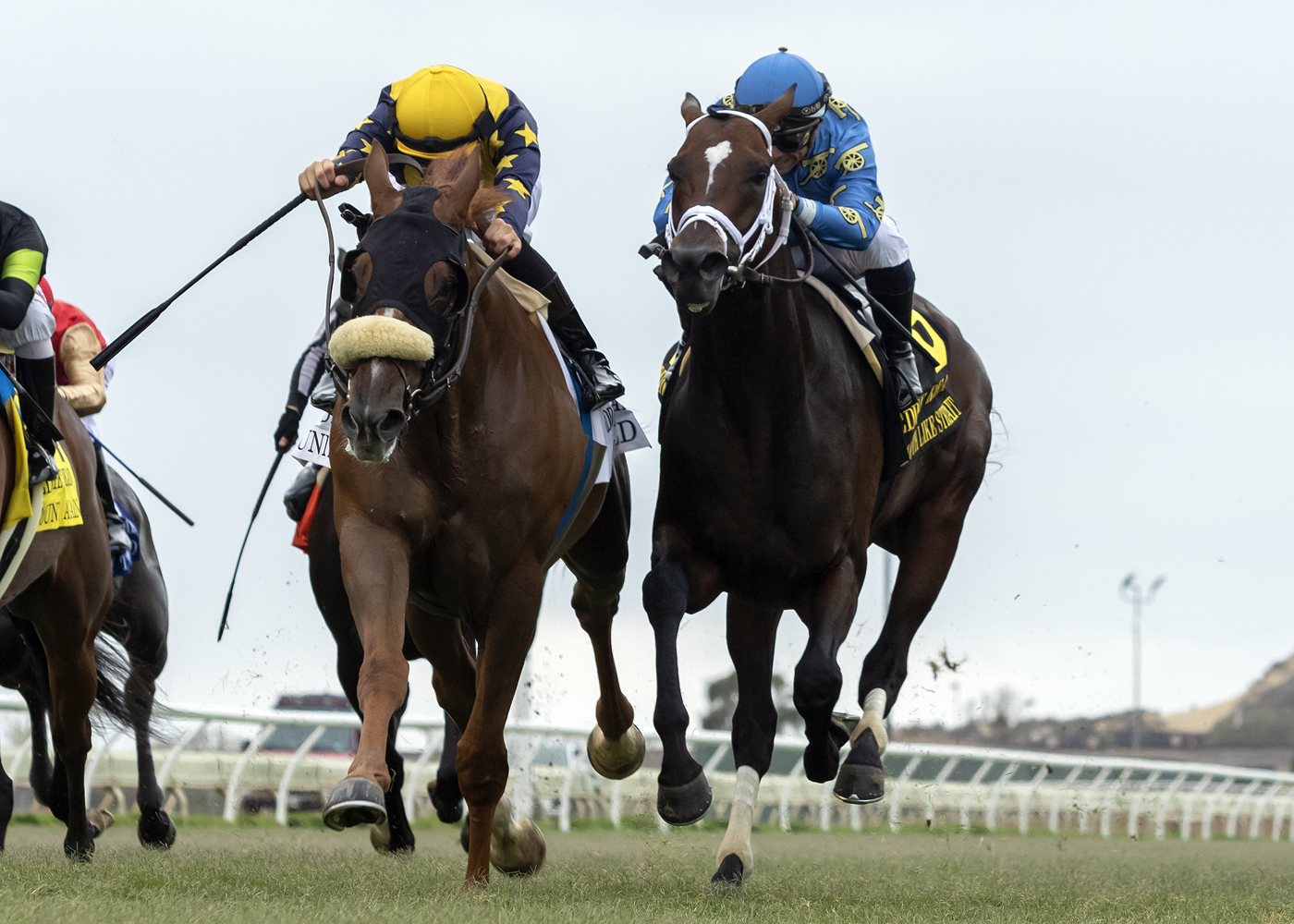 United (left) lowers his head and pushes past Smooth Like Strait in the Eddie Read.7-24-2021