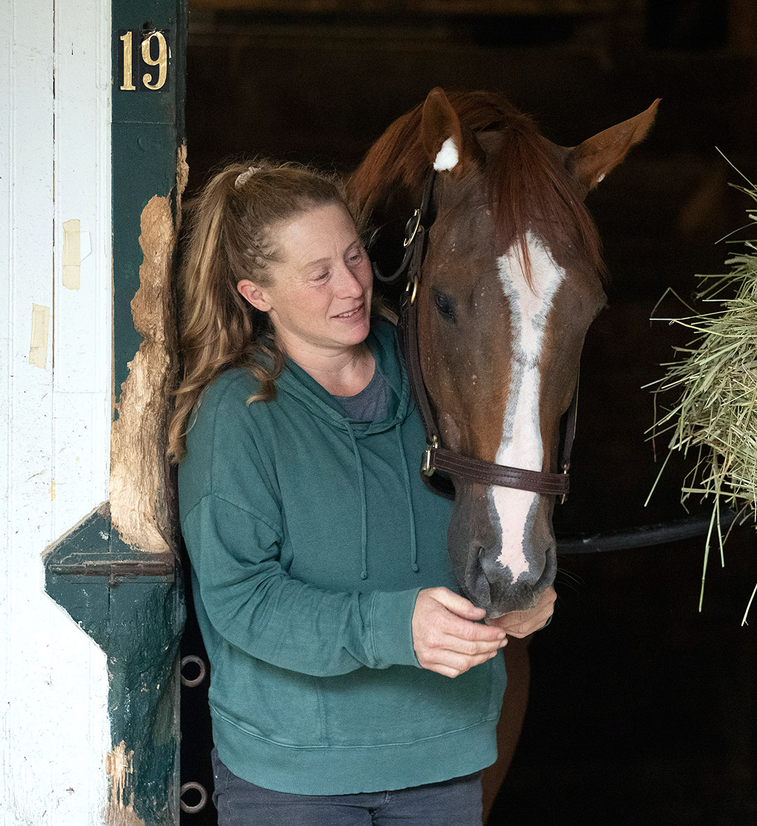 Laura Moquett with Whitmore in his stall at Saratoga Race Course on Aug. 30